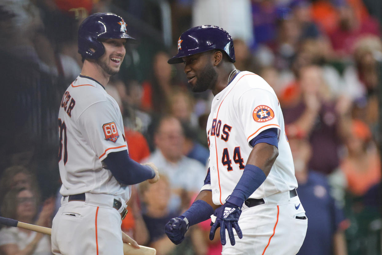 Yordan Alvarez #44 of the Houston Astros high fives Kyle Tucker #30 of the Houston Astros 