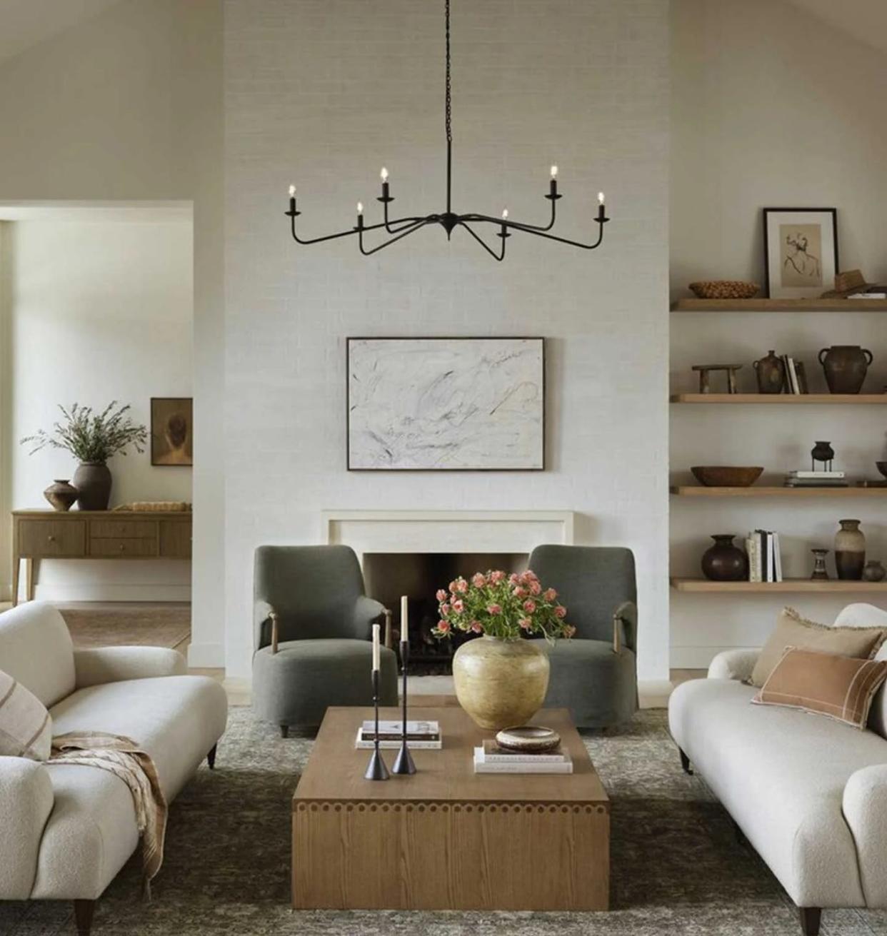 a living room with a chandelier and a table