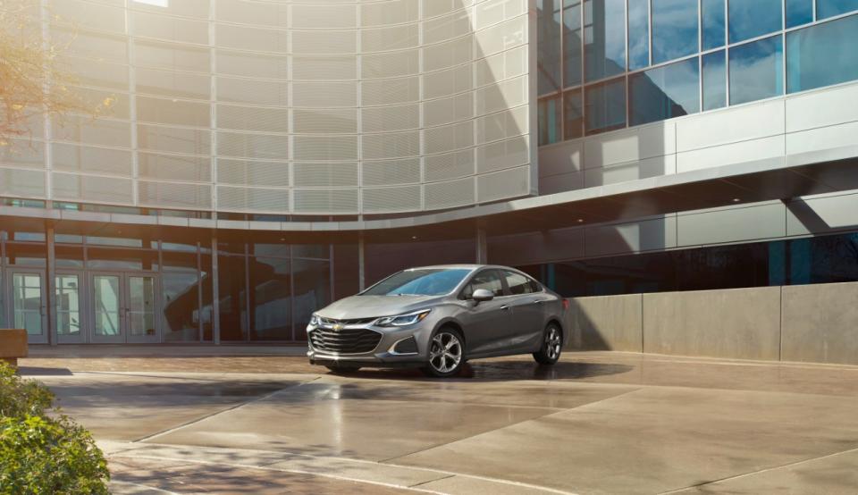 A Chevy Cruze parked in front of a building