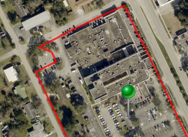 This is a screenshot from the Volusia County Property Appraiser's website showing an aerial view of the former Florida Health Care Plans headquarters/Daytona Beach General Hospital property at 1340 Ridgewood Ave. in Holly Hill. The property was sold in August 2023 to a developer that plans to gut and renovate the interior of the three-story building on the south and tear down the single-story building on the north to make way for a new three-story Devon Self Storage Center.