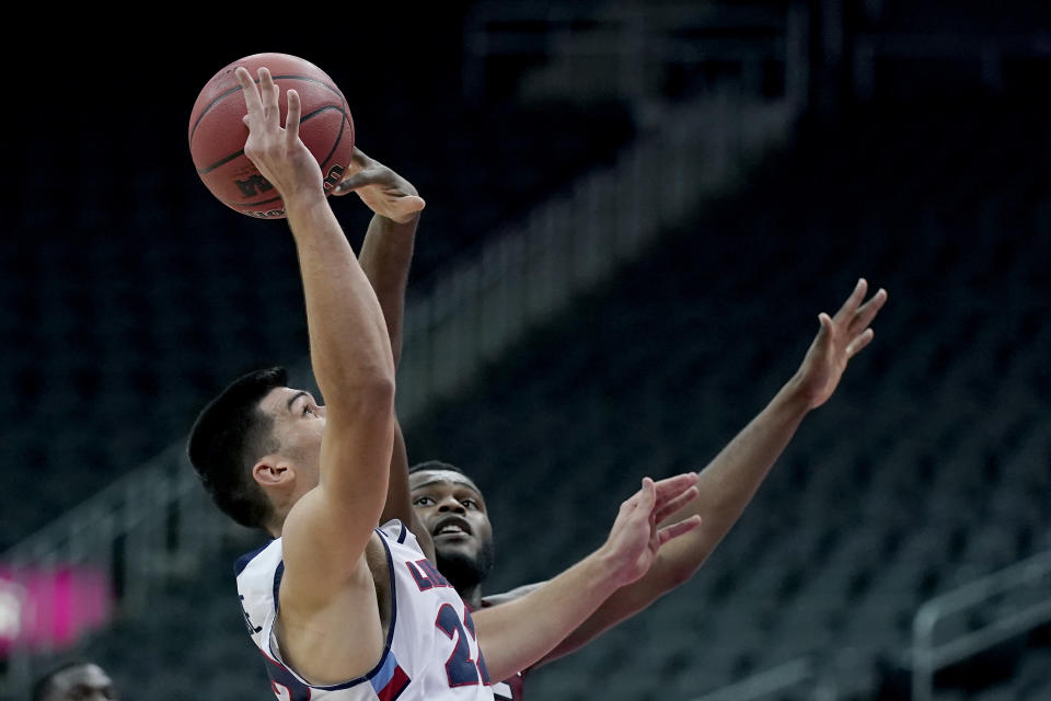 South Carolina's Wildens Leveque, right, blocks a shot by Liberty's Kyle Rode, left, during the second half of an NCAA college basketball game Saturday, Nov. 28, 2020, at the T-Mobile Center in Kansas City, Mo. (AP Photo/Charlie Riedel)