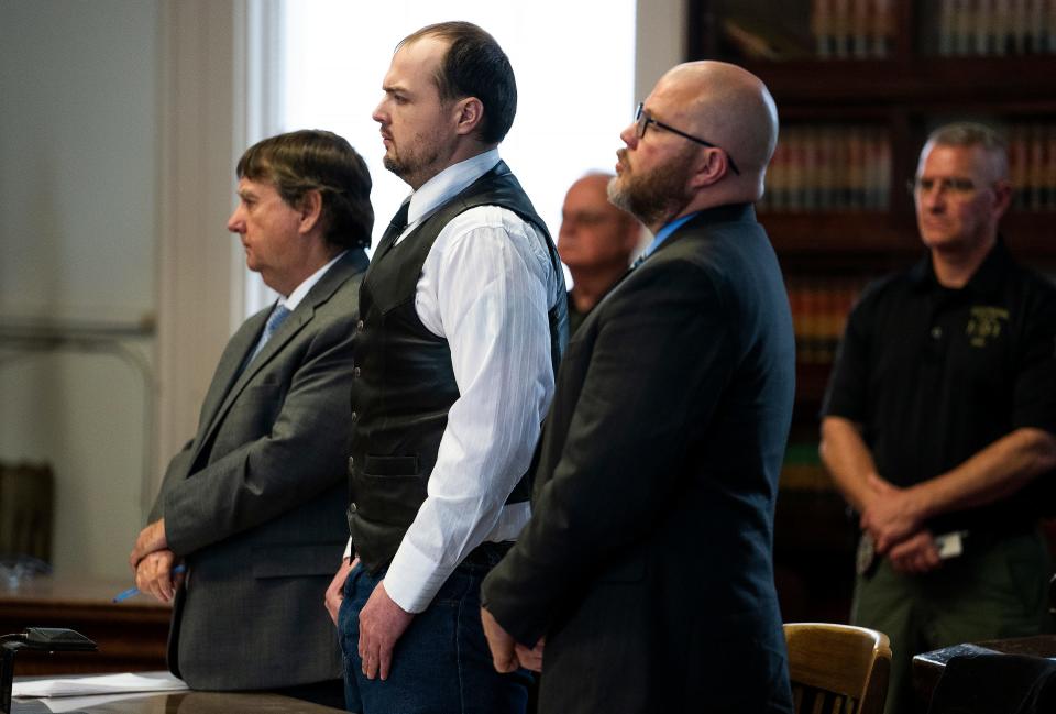 George Wagner IV, center, stands next to attorneys John P. Parker and Richard M. Nash while he receives his sentence from Judge Randy Deering.