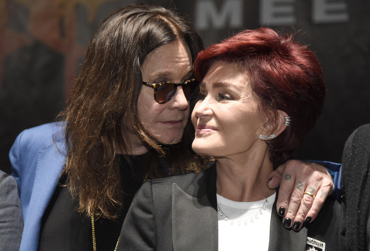 Ozzy Osbourne, left, joins his wife Sharon onstage during the "Ozzfest Meets Knotfest" news conference at the Hollywood Palladium on Thursday, May 12, 2016, in Los Angeles. The "Ozzfest Meets Knotfest" multi-stage camping festival on Sept. 24-25 at the San Manuel Amphitheater and Festival Grounds in San Bernardino, Calif. was announced at the news conference. (Photo by Chris Pizzello/Invision/AP)