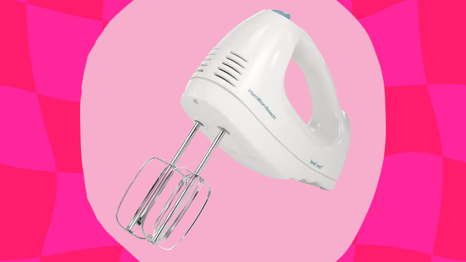 the white Hamilton Beach hand mixer against a pink background