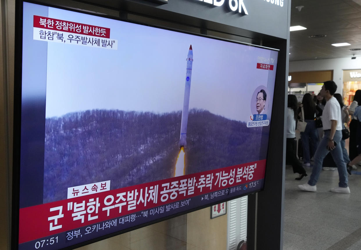 A TV screen shows a file image of North Korea's rocket launch during a news program at the Seoul Railway Station in Seoul, South Korea, Wednesday, May 31, 2023. North Korea launched a purported rocket Wednesday, a day after the country announced a plan to put its first military spy satellite into orbit, South Korea's military said. (AP Photo/Ahn Young-joon)