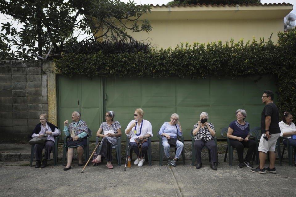 People wait to vote in the opposition presidential primary election in the Petare area of Caracas, Venezuela, Sunday, Oct. 22, 2023. The opposition will pick one candidate to challenge President Nicolás Maduro in 2024 presidential elections. (AP Photo/Ariana Cubillos)