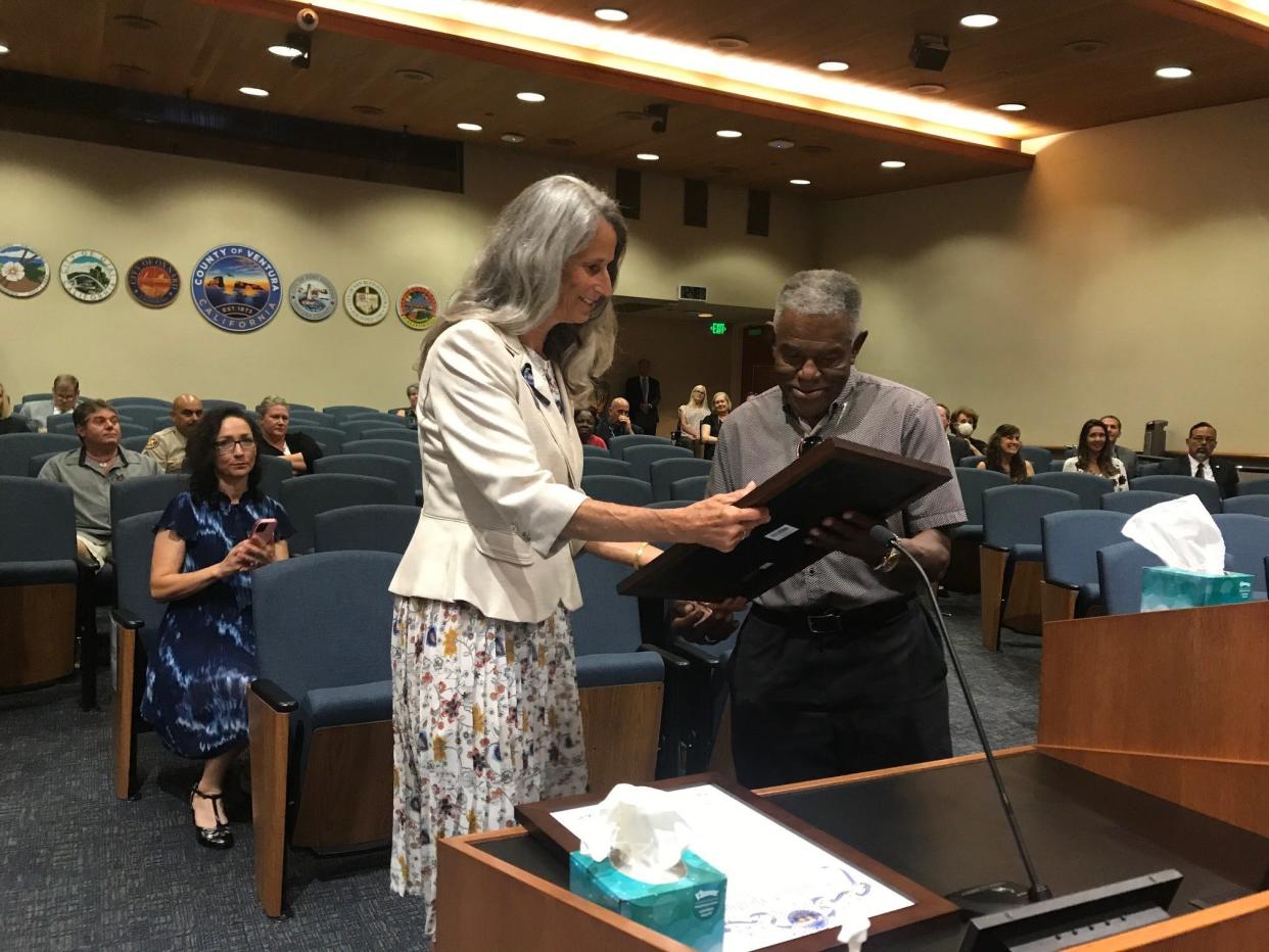 Supervisor Linda Parks presents a resolution honoring Leroy "Buddy" Gibson Jr., designer of the first county flag. The presentation was made Sept. 13 at the County Government Center in Ventura.