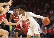 Nebraska's Alonzo Verge Jr. (1) drives against Wisconsin's Chris Vogt (33) and Lorne Bowman II (11) during the first half of an NCAA college basketball game Thursday, Jan. 27, 2022, in Lincoln, Neb. (AP Photo/Rebecca S. Gratz)