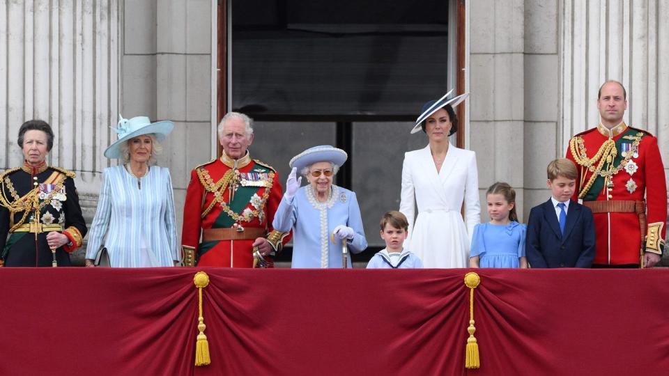 Britain's Queen Elizabeth II (C) stands with from left, Britain's Princess Anne, Princess Royal, Britain's Camilla, Duchess of Cornwall, Britain's Prince Charles, Prince of Wales, Britain's Prince Louis of Cambridge, Britain's Catherine, Duchess of Cambridge, Britain's Princess Charlotte of Cambridge , Britain's Prince George of Cambridge, Britain's Prince William, Duke of Cambridge , to watch a special flypast from Buckingham Palace