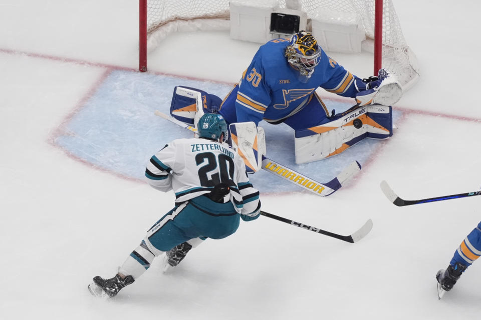 St. Louis Blues goaltender Joel Hofer (30) stops a shot from San Jose Sharks' Fabian Zetterlund (20) during the second period of an NHL hockey game Saturday, March 30, 2024, in St. Louis. (AP Photo/Jeff Roberson)