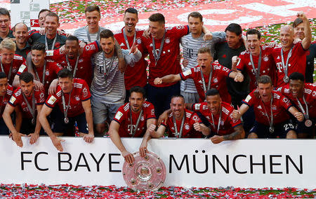 Soccer Football - Bundesliga - Bayern Munich v VfB Stuttgart - Allianz Arena, Munich, Germany - May 12, 2018 Bayern Munich players celebrate winning the Bundesliga with the trophy REUTERS/Michaela Rehle