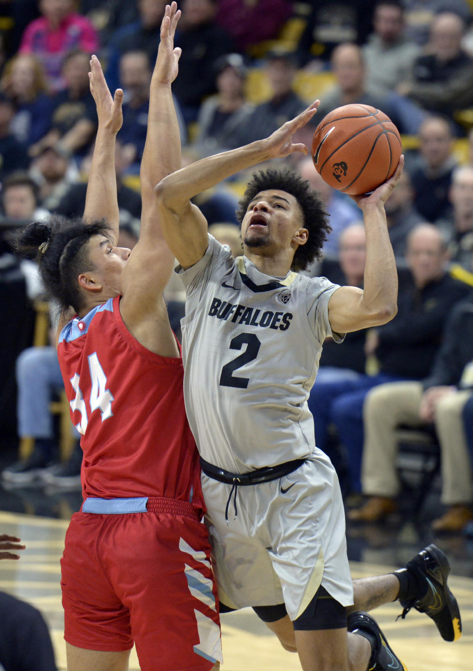 Colorado guard Daylen Kountz, right, is defended by Loyola Marymount forward Keli Leaupepe during the second half of an NCAA college basketball game Wednesday, Dec. 4, 2019, in Boulder, Colo. (AP Photo/Cliff Grassmick)