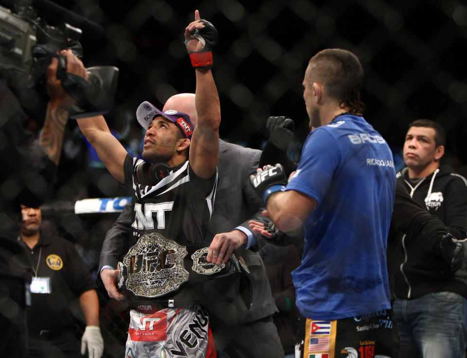 Jose Aldo, left of Brazil celebrates after beating Ricardo Lamas of Chicago, IL in five rounds of the Ultimate Fighting Featherweight Championship Mix Martial Arts bout in Newark, N.J. on Saturday, Feb. 1, 2014. Aldo won by unanimous decision in five rounds. (AP Photo/Tim Larsen)