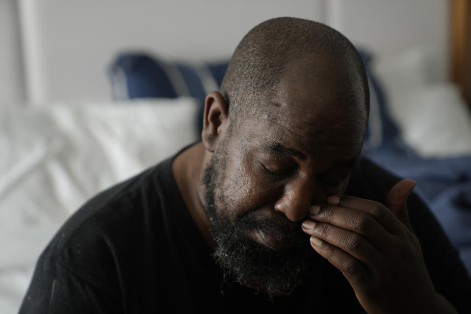 Freddie Davis rests in a hotel room where, with the help of a nonprofit that assists homeless people, he will be living temporarily, after being evicted from his one-bedroom apartment, Wednesday, Sept. 29, 2021, in Miami. Davis' landlord raised his rent by 60 percent in August 2020, the same month he lost his job as a truck driver when the company he worked for folded during the pandemic. (AP Photo/Rebecca Blackwell)