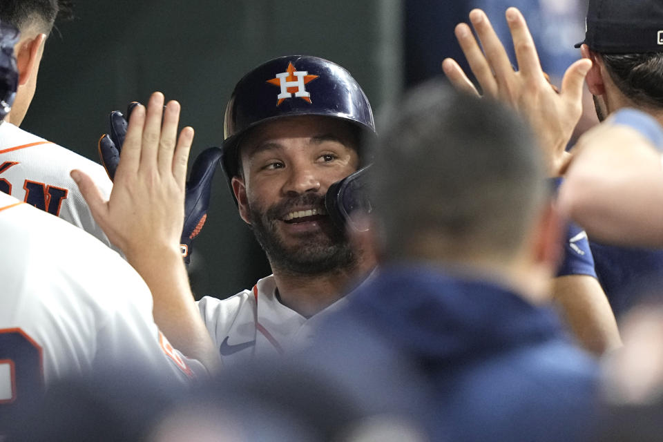 Houston Astros' Jose Altuve celebrates in the dugout after hitting a home run against the New York Mets during the third inning of a baseball game Tuesday, June 21, 2022, in Houston. (AP Photo/David J. Phillip)