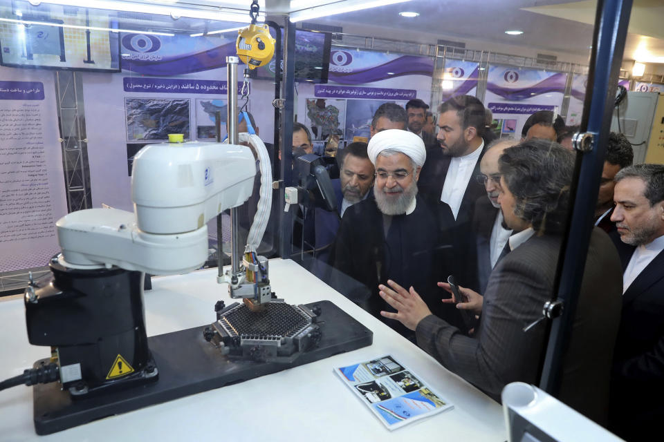 FILE - In this April 9, 2018, file photo, released by an official website of the office of the Iranian Presidency, President Hassan Rouhani listens to explanations on new nuclear achievements at a ceremony to mark "National Nuclear Day," in Tehran, Iran. Iranian Foreign Minister Mohammad Javad Zarif acknowledged Monday, July 1, 2019, Iran had broken the limit set on its stockpile of low-enriched uranium by the 2015 nuclear deal, marking its first major departure from the unraveling agreement a year after the U.S. unilaterally withdrew from the accord. (Iranian Presidency Office via AP)