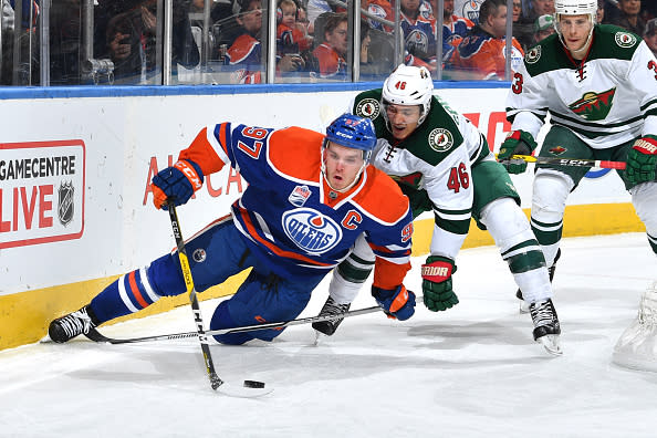 EDMONTON, AB - DECEMBER 4: Connor McDavid #97 of the Edmonton Oilers is tripped up by Jared Spurgeon #46 of the Minnesota Wild on December 4, 2016 at Rogers Place in Edmonton, Alberta, Canada. (Photo by Andy Devlin/NHLI via Getty Images)