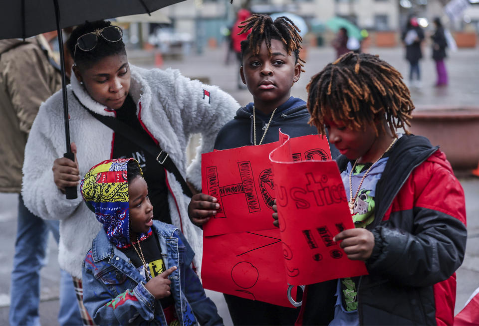 Nakia Harrison, left, along with her children Darius, Devonte, and Daniel Smith, attend a rally for Tyre Nichols, who died after being beaten by Memphis police during a traffic stop, in Memphis, Tenn., on Saturday, Jan. 28, 2023. (Patrick Lantrip/Daily Memphian via AP)