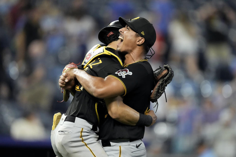 Pittsburgh Pirates starting pitcher Johan Oviedo, right, celebrates with catcher Endy Rodriguez after their baseball game against the Kansas City Royals Monday, Aug. 28, 2023, in Kansas City, Mo. Oviedo pitched a complete game leading the Pirates to a 5-0 win. (AP Photo/Charlie Riedel)