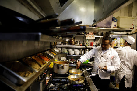 Abdul Ahad, owner of the City Spice curry house, cooks a vegan meal in the kitchen of his restaurant on Brick Lane in London, Britain January 7, 2019. Picture taken January 7, 2019. REUTERS/Simon Dawson