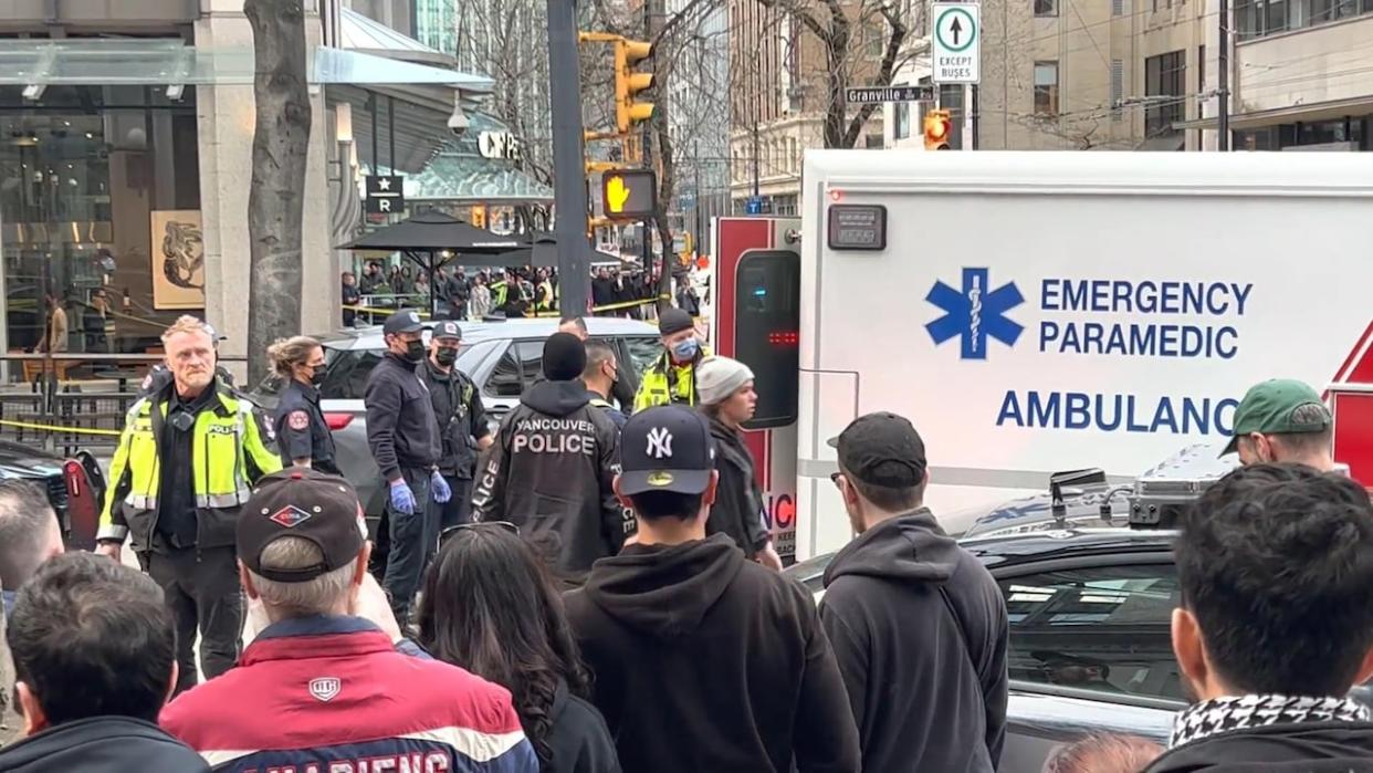 Emergency responders respond to the stabbing at the Starbucks at Granville and Dunsmuir streets in downtown Vancouver on March 26, 2023. (Nick Logan/CBC - image credit)