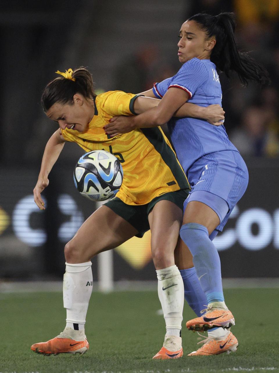 Australia's Hayley Raso, left, and France's Sakina Karchaoui compete for the ball during their friendly soccer match in Melbourne, Friday, July 14, 2023, ahead of the Women's World Cup. (AP Photo/Hamish Blair)