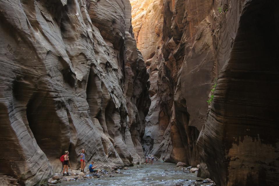 Visitors explore The Narrows at Zion National Park in Utah on July 15, 2014.