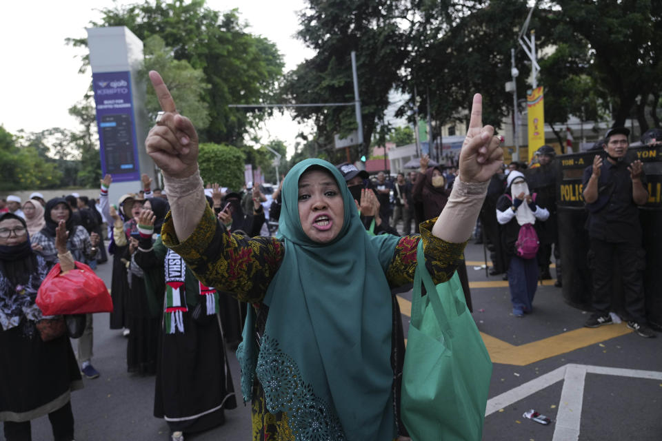 A Muslim shouts slogans during a rally against British band Coldplay ahead of its concert in Jakarta, Indonesia, Wednesday, Nov. 15, 2023. A group of conservative Muslims staged the rally calling for the cancellation of the concert over the band's support for the LGBTQ+ community. (AP Photo/Tatan Syuflana)