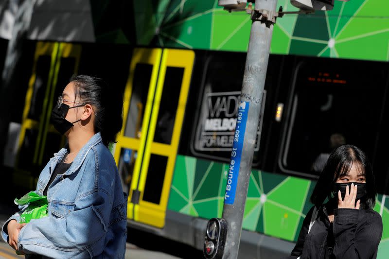FILE PHOTO: People wearing face masks walk on Bourke Street after cases of the coronavirus were confirmed in Melbourne