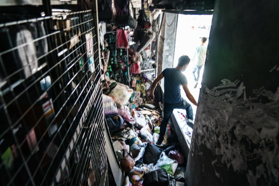 A shopkeeper exits a store damaged by bombings in Gaza City.