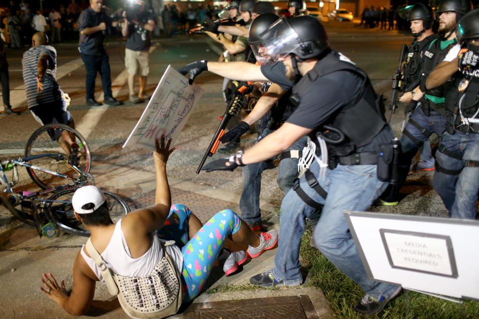 <p>Police officers arrest a demonstrator on August 18, 2014 in Ferguson, Missouri. Violent outbreaks have taken place in Ferguson since the shooting death of unarmed teenager Michael Brown by a Ferguson police officer on August 9th. (Joe Raedle/Getty Images) </p>