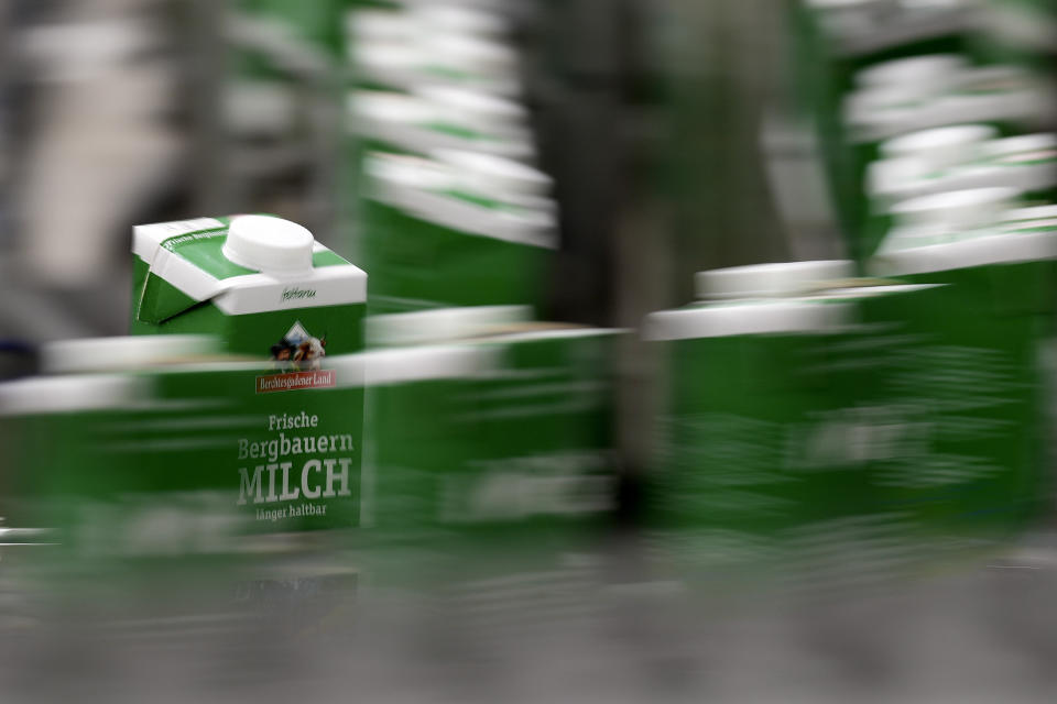 Milk packs move down the production line at the Berchtesgadener Land dairy cooperative in Piding near Munich, Germany, Friday, July 15, 2022. The Molkerei Berchtesgadener Land has stockpiled 200,000 liters of fuel oil so it can continue to produce electricity and steam if natural gas supplies to its turbine generator are cut off. (AP Photo/Matthias Schrader)