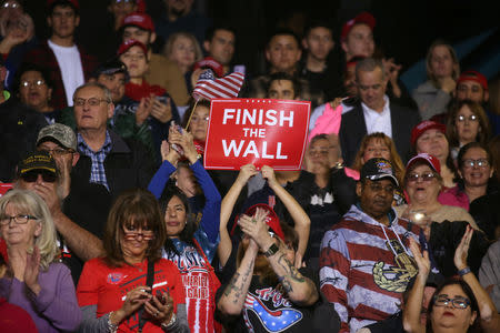 Supporters hold a placard as U.S. President Donald Trump holds a rally at El Paso County Coliseum in El Paso, Texas, U.S., February 11, 2019. REUTERS/Leah Millis