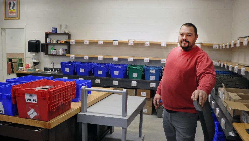 Wayne County Public Library Operations Coordinator Dave Tenney stands in the room where daily deliveries are made, sorted and sent out to all of the county's library branches.