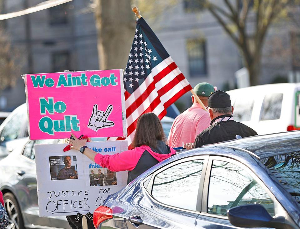 Protesters gather on High Street, 200 feet away from Norfolk Superior Court in Dedham on Monday, April 29, 2024, for the first day of the Karen Read murder trial in the death of Boston police officer John O'Keefe.