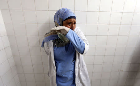 A colleague of Palestinian nurse Razan Al-Najar, who was killed during a protest at the Israel-Gaza border, reacts at a hospital in the southern Gaza Strip June 1, 2018. REUTERS/Ibraheem Abu Mustafa