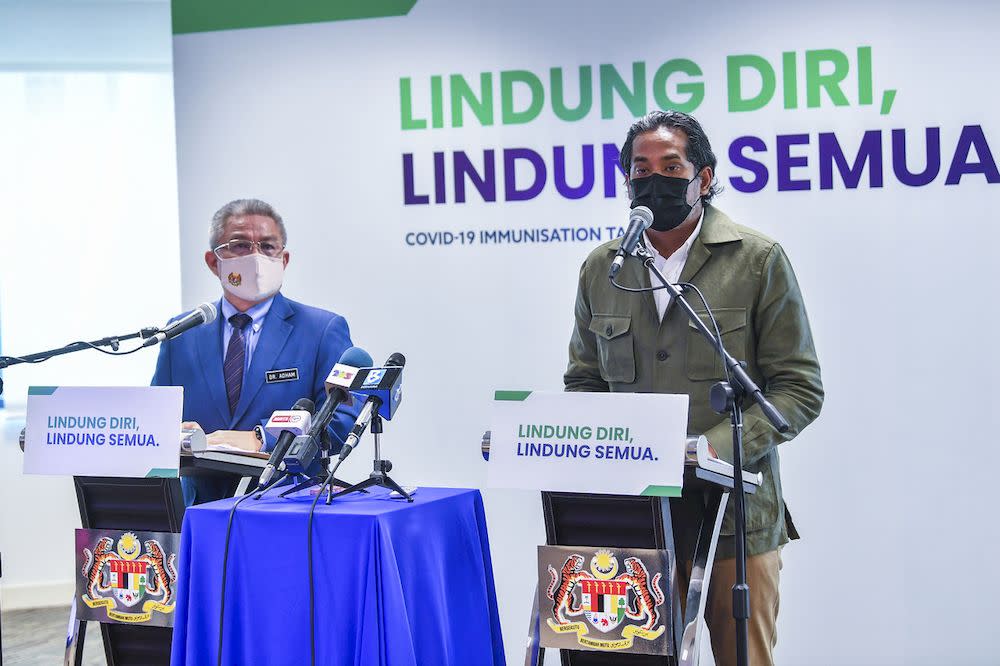 Coordinating Minister for National Covid-19 Immunisation Programme Khairy Jamaluddin (right) at a press conference in Putrajaya, April 12, 2021 with Health Minister Datuk Seri Dr Adham Baba on the latest development of the National Covid-19 immunisation Programme. — Bernama pic