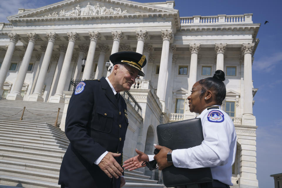 FILE - In this July 23, 2021, file photo J. Thomas Manger, left, a veteran police chief of departments in the Washington, D.C., region, is welcomed by interim acting Capitol Police chief Yogananda Pittman, to the Capitol in Washington as he takes over the United States Capitol Police following the resignations of the previous leadership after the Jan. 6 insurrection. Pittman, the Capitol Police official who led intelligence operations when thousands of pro-Trump rioters descended Jan. 6, is back in charge of intelligence as officials prepare for what’s expected to be a massive rally at the Capitol to support those who took part in the insurrection. Pittman has been put back in charge as assistant chief of the agency’s intelligence operations and supervising officers who protect top congressional leaders. (AP Photo/J. Scott Applewhite, File)