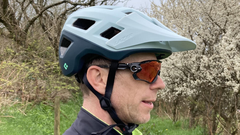  Side profile of man wearing Lazer Coyote KinetiCore mountain bike helmet 