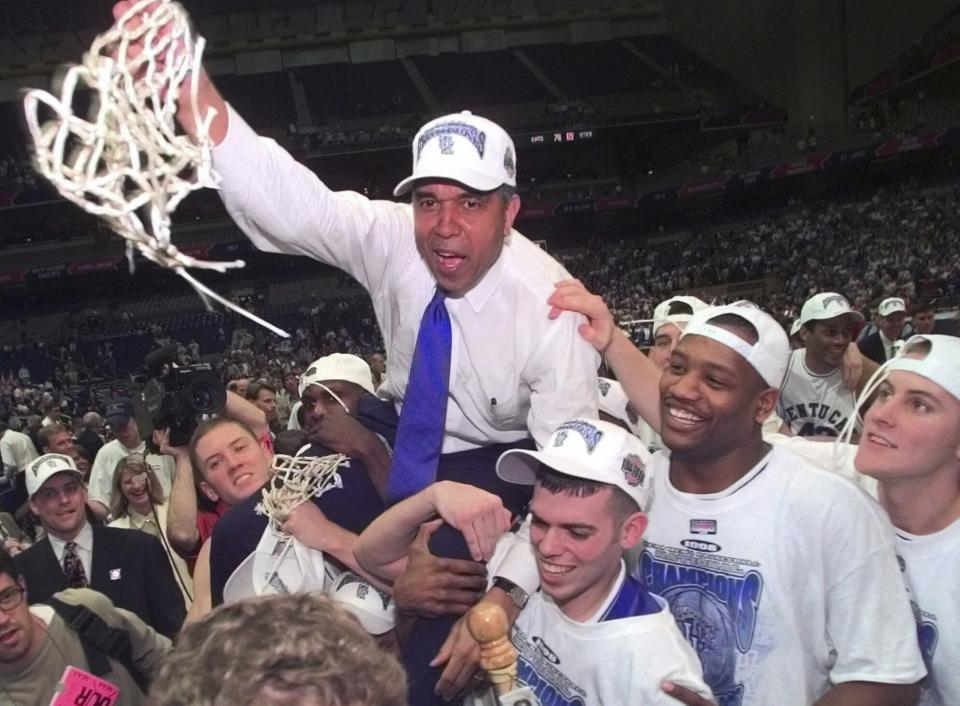 FILE - Kentucky coach Tubby Smith is carried off the court by game MVP Jeff Sheppard, left, Steve Masiello, center right, and Jamaal Maglioire second from right front after beating Utah 78-69 in the Final Four NCAA championship game at the Alamodome in San Antonio Monday, March 30, 1998. (AP Photo/Eric Draper, FIle)