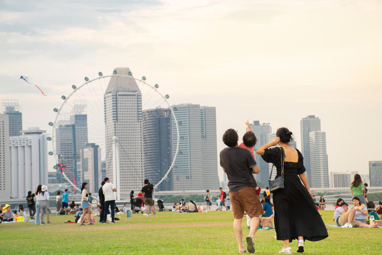 Singapore - 13 OCT 2019: Father embracing his daughter while they walking into the symbolic Ferris wheel at Marina barrage where not only supplied water to Singapore’s citizen but also doubled up as a place for family outing.