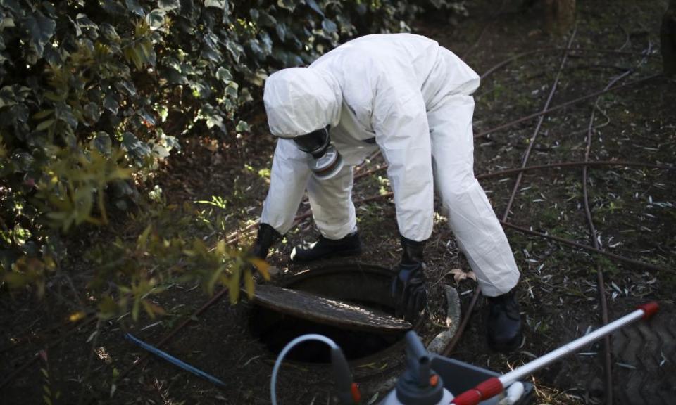 A firefighter in Marseille extracts samples of sewage water at a retirement home in Marseille, France.