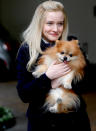 <p>Julia Garner cuddles up to a Pomeranian on the set of upcoming TV miniseries <i>Inventing Anna</i> on Tuesday in N.Y.C. </p>