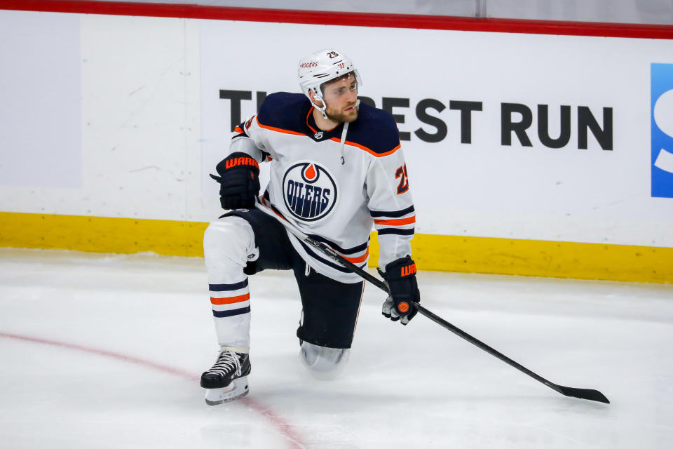 WINNIPEG, MB - MAY 24: Leon Draisaitl #29 of the Edmonton Oilers kneels dejectedly on the ice following a 4-3 triple overtime loss against the Winnipeg Jets in Game Four of the First Round of the 2021 Stanley Cup Playoffs at the Bell MTS Place on May 24, 2021 in Winnipeg, Manitoba, Canada. The Jets sweep the series 4-0. (Photo by Jonathan Kozub/NHLI via Getty Images)