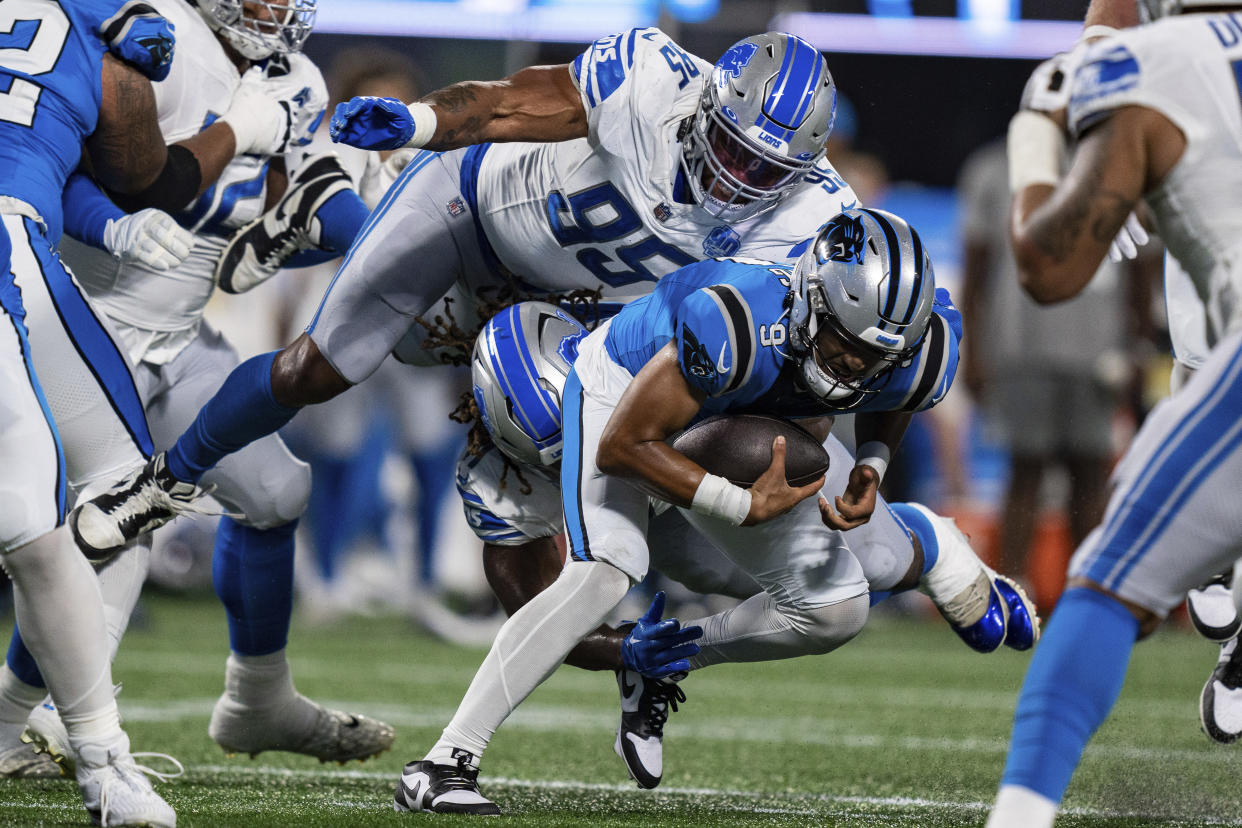 Carolina Panthers quarterback Bryce Young (9) is sacked by Detroit Lions linebacker James Houston (41) and Detroit Lions defensive end Romeo Okwara (95) during a preseason NFL football game Friday, Aug. 25, 2023, in Charlotte, N.C. (AP Photo/Jacob Kupferman)