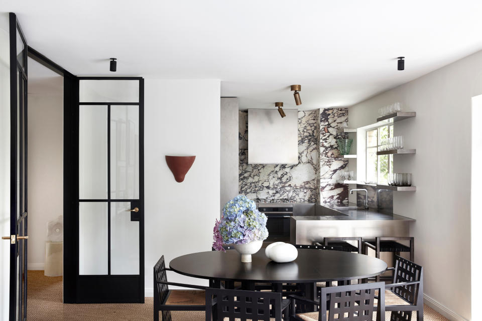 a stainless steel and marble kitchen