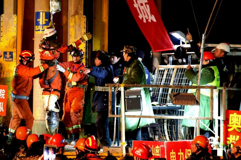 Rescuers free four miners who were among 29 trapped when a mine collapsed on December 25 in Pingyi County, eastern China's Shandong province