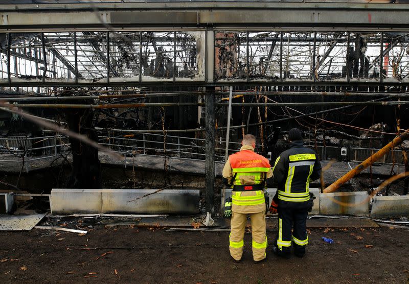 Firefighters observe a burned monkey house in the zoo of Krefeld