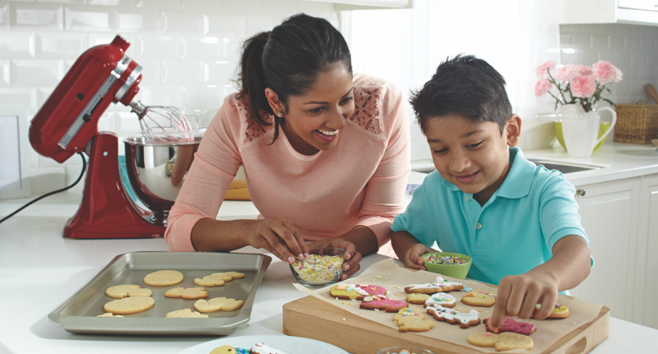 Mother and son decorating cookies with products from Canadian Tire