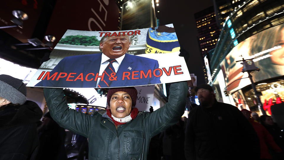 NEW YORK, NEW YORK - DECEMBER 17: Demonstrators join national impeachment demonstrations to demand an end to Donald Trump's presidency named "Nobody Is Above The Law" Rally - NYC at Times Square on December 17, 2019 in New York City. (Photo by John Lamparski/Getty Images for MoveOn.org)